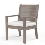 Front angle showing thick white seat cushion and wood-like aluminum frame texture