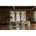 Excelsior sofa in loft-style room with exposed brick, large windows, and modern seating setup