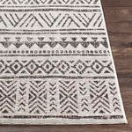 Close-up of geometric pattern showing detailed border along edge on wooden floor