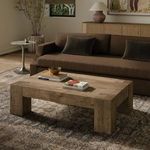 Living room setting focusing on coffee table with books and decorative bowl on top