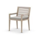 Chair in soft light, angled slightly to showcase armrest detail and cushion fabric