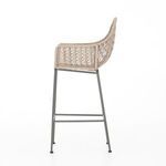 Front view highlighting woven wicker seat and backrest with footrest bars