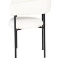 Side angle showing the curved armrest and back design with black metal legs of the Cassia Dining Chair
