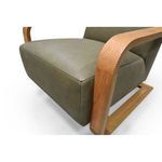 Close-up of oak armrest with visible wood grain and corner joinery next to olive leather seat cushion