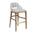 Three-quarter front angle of Inga Stool highlighting fabric texture and brass footrest