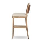 Side profile of stool highlighting curved backrest frame and seat thickness