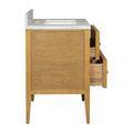 Top-down view of rectangular undermount sink set within marble countertop with backsplash