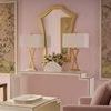 Chatsworth Console Table styled in pink room with gold-framed mirror, floral artwork, and matching lamps