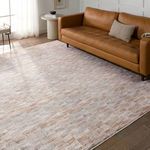 Living room setup with rug under leather sofa, showcasing scale and color integration