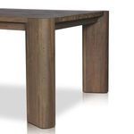 Angled view of thick, rounded rectangular table leg with wood grain detail