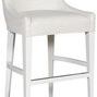 Cove Stool angled view showing the sloped backrest and cushioned seat with smooth white fabric texture