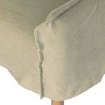 Close-up of khaki linen slipcover seam detail along chair side