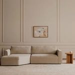 Beige Madrid sectional sofa staged with wood side table and modern beige armchair in elegant room