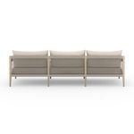 Rear view showcasing the woven rope detail on the back frame of the sand-colored outdoor sofa