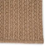 Close-up of thick braided rope-like texture and handwoven border in solid light tan