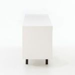 Narrow side profile showing solid white lacquer finish and metal legs