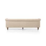 Rear view of sofa showing smooth fabric upholstery and wooden legs