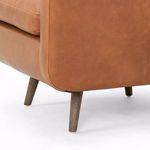 Detail view of tapered wire-brushed parawood leg on Kaya leather swivel chair