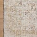 Detailed top view close-up of decorative floral and border design on Marcella Sage Gold Rug on wood floor
