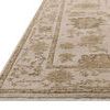 Close-up angled view showing low pile texture and detailed border of Willa Fog Natural Rug