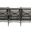 Back of sofa showing three-frame sections with decorative circular metal accents