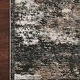 Close-up of Estelle Charcoal Granite rug corner lying flat on dark hardwood floor