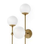Close-up side view of Armstrong 4 L Sconce showing three matte globes and brass wall mount