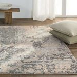 Close front view with two stacked decorative pillows on the rug near a sheer curtain