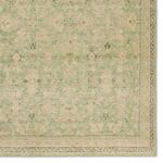 Close-up focusing on detailed floral border and intricate trellis motifs