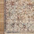 Top corner of rug on wood floor highlighting intricate border and pattern details