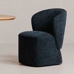 Navy Larson chair styled beside a light wood dining table in a neutral room setting