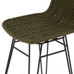 Detail of woven green rope seat showing thick rope strands and metal frame beneath