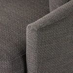 Close-up of fabric weave and stitchwork on armrest corner of chair