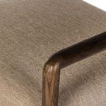 Close-up of chair armrest showing wood grain and smooth rounded shape