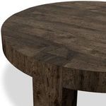 Close-up of round table edge revealing wood grain, joinery, and textured veneer surface
