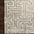 Corner view of rug on dark wood floor highlighting pile texture and edge finishing