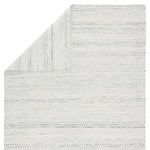 Reversed corner fold revealing back side with lighter shade of cream and gray weave