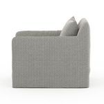 Side view of Dade Outdoor Swivel Chair showing continuous armrest and backrest curve in fabric