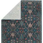 Backside of rug flipped revealing light blue underside and edge detailing