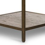 Bottom corner detail highlighting bronze frame and oak lower shelf texture