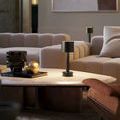 Traverse lamp on beige marble coffee table in modern living room with taupe sectional