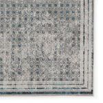 Zoomed-in corner showing intricate trellis pattern and layered narrow borders with soft pile