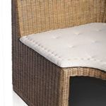 Close-up of beige fabric cushion with subtle tufted button detail on bench seat