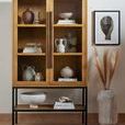 Iker vase styled beside neutral fireplace, surrounded by modern decor elements and plush cushions