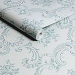 Close-up of rolled Rachel Ashwell Boudoir Beauty wallpaper showing texture and pattern scale