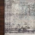 Corner view of charcoal multi rug styled on dark hardwood floor highlighting intricate pattern and color variation