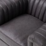 Close-up on dark gray leather seat cushion showing natural grain texture