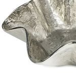 Close-up of textured, shiny ruffled edge of Pedicoat Metal Bowl with wavy metal surface