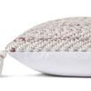 Side view of the Devon Blush / Natural Pillow showing white solid fabric on the back and tassel detail