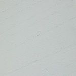 Close-up detail of white paint finish with fine brush texture on end table surface